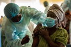 A health worker administers COVID-19 vaccine on a female patient in Luanda, Angola