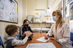 Two children at a doctor's office, wearing masks, in Uruguay