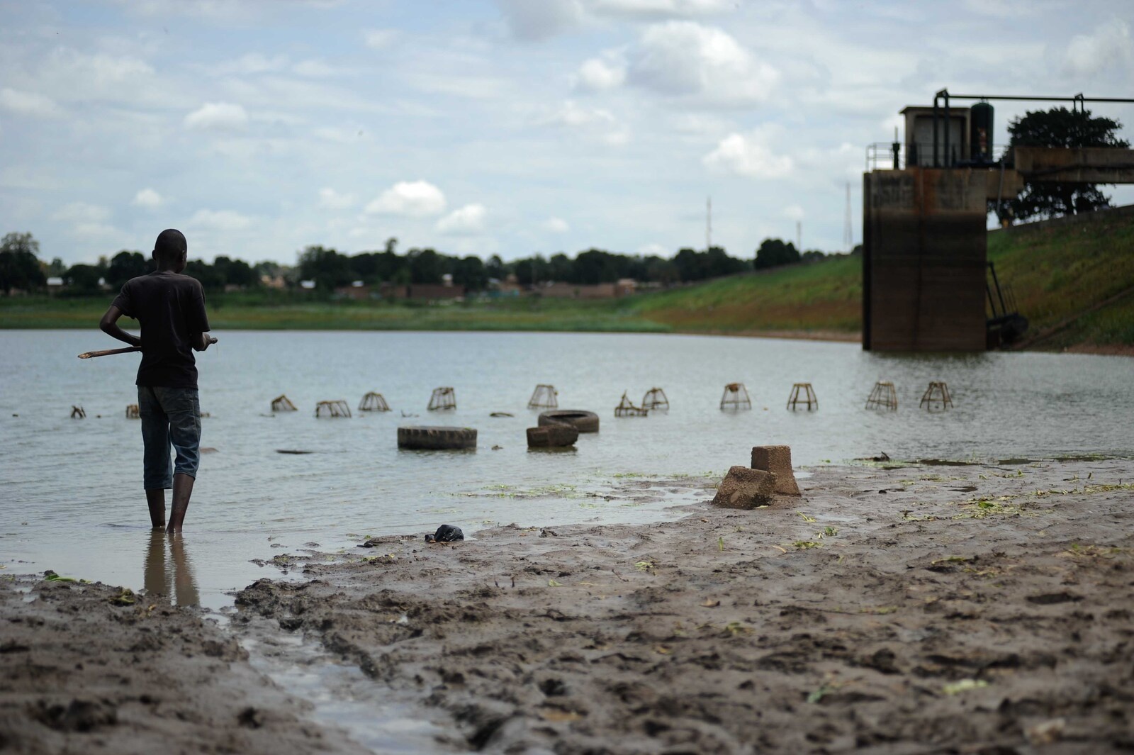 A boy standing in water in Korhogo, Cote d'Ivoire