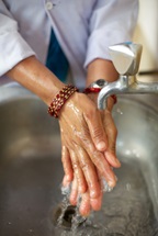 Hand washing over a sink