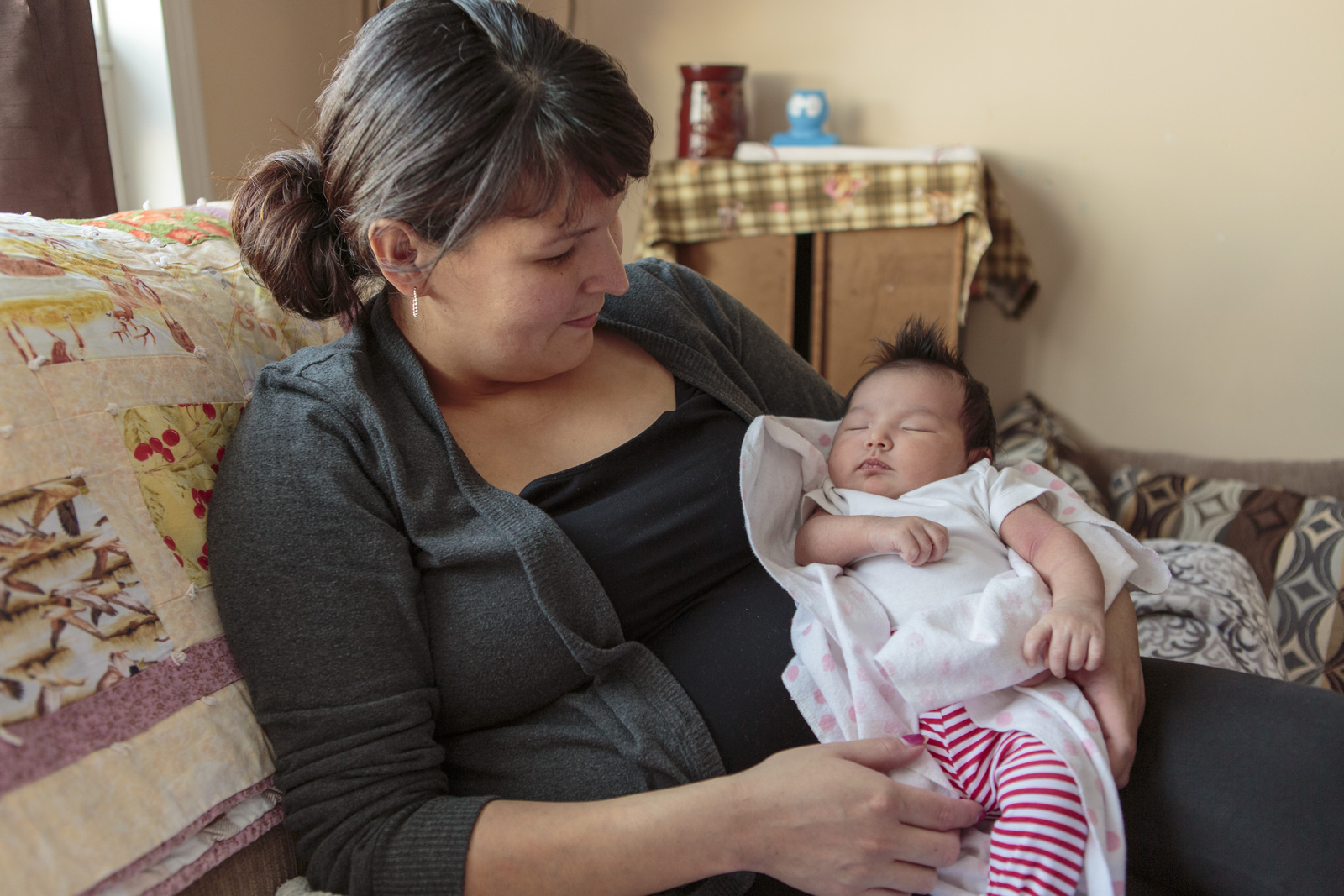 A mother holding her newborn baby in Northern Canada