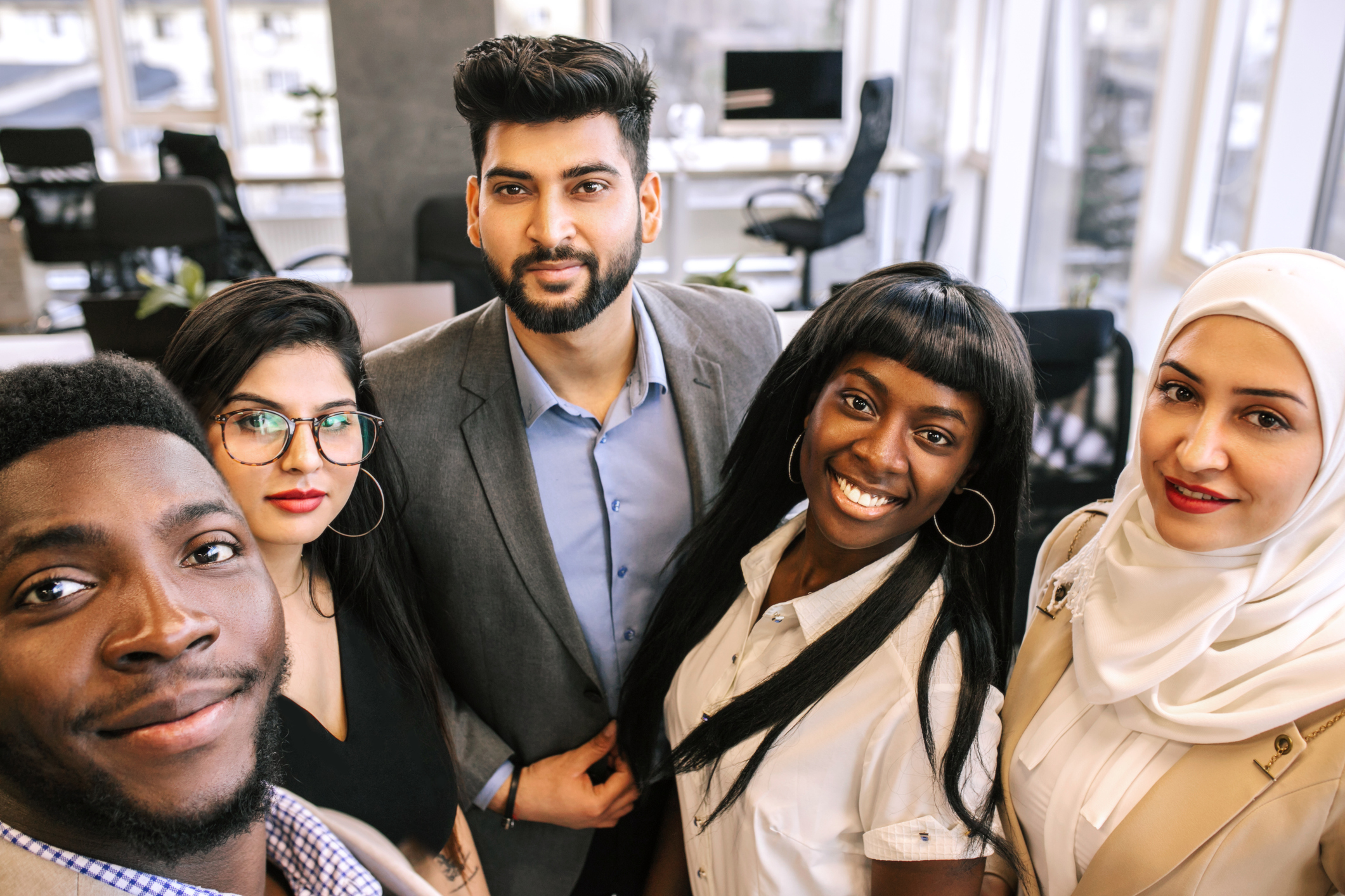 Successful multiracial business team making selfie at office together