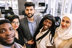 Successful multiracial business team making selfie at office together
