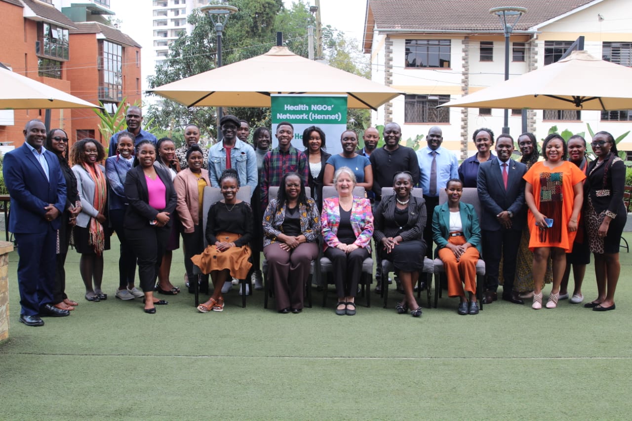 A group of people at a meeting in Kenya pose for a group photo