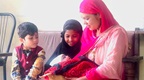 Two children and a newborn with their mother, in Nepal