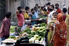 Vegetable sellers at market, wearing masks, in India
