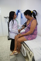 A pregnant woman getting her blood pressure measured, in Colombia