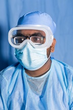Health worker with protective googles and mask at Rohingya refugee camp, during COVID-19 pandemic, in Bangladesh