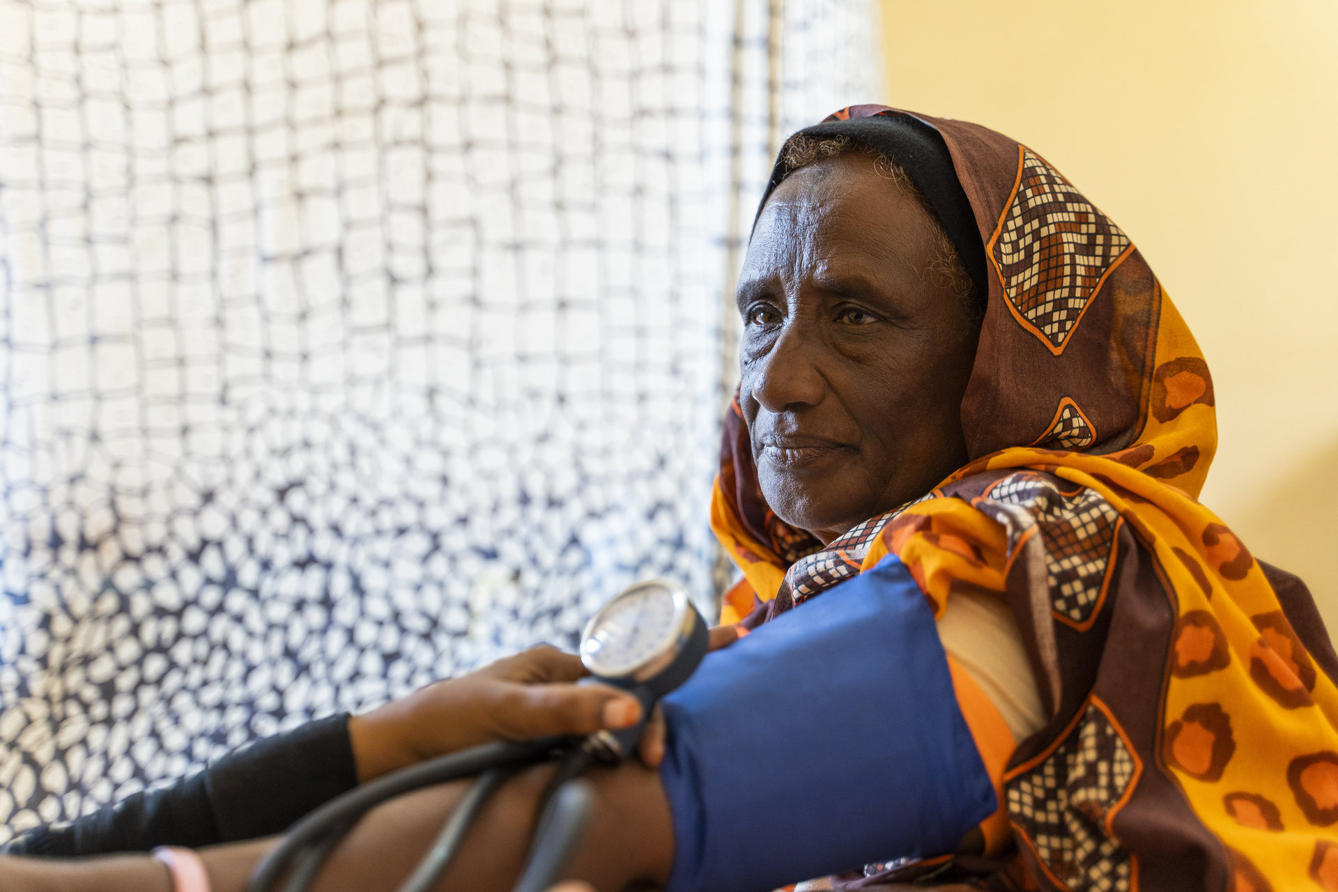 A woman in Wad Madani, Sudan has her blood pressure measured, in 2023.