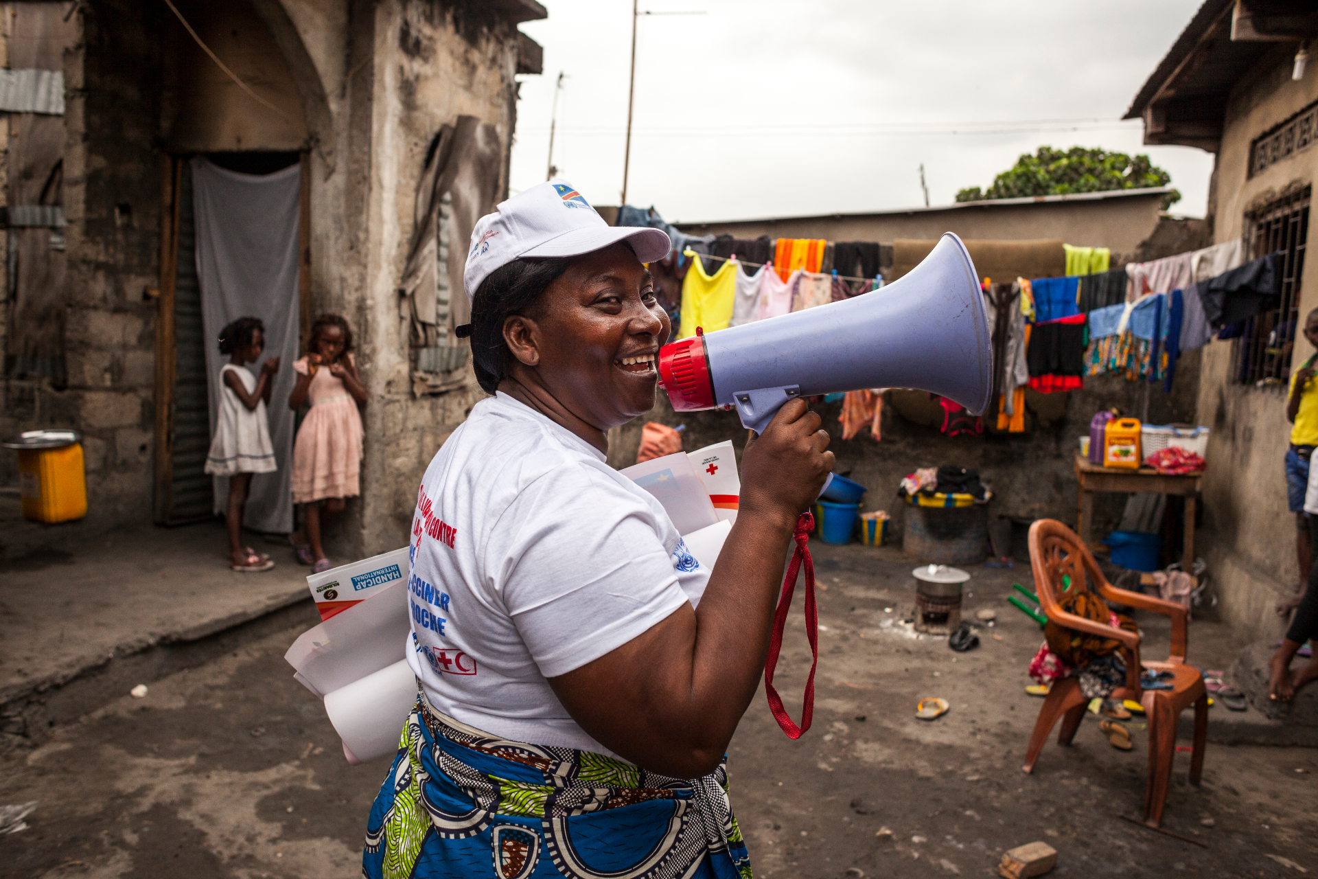 A social mobiliser speaking into a megaphone at the slum of Pakajuma during a yellow fever vaccination campaign in Kinshasa, Democratic Republic of the Congo